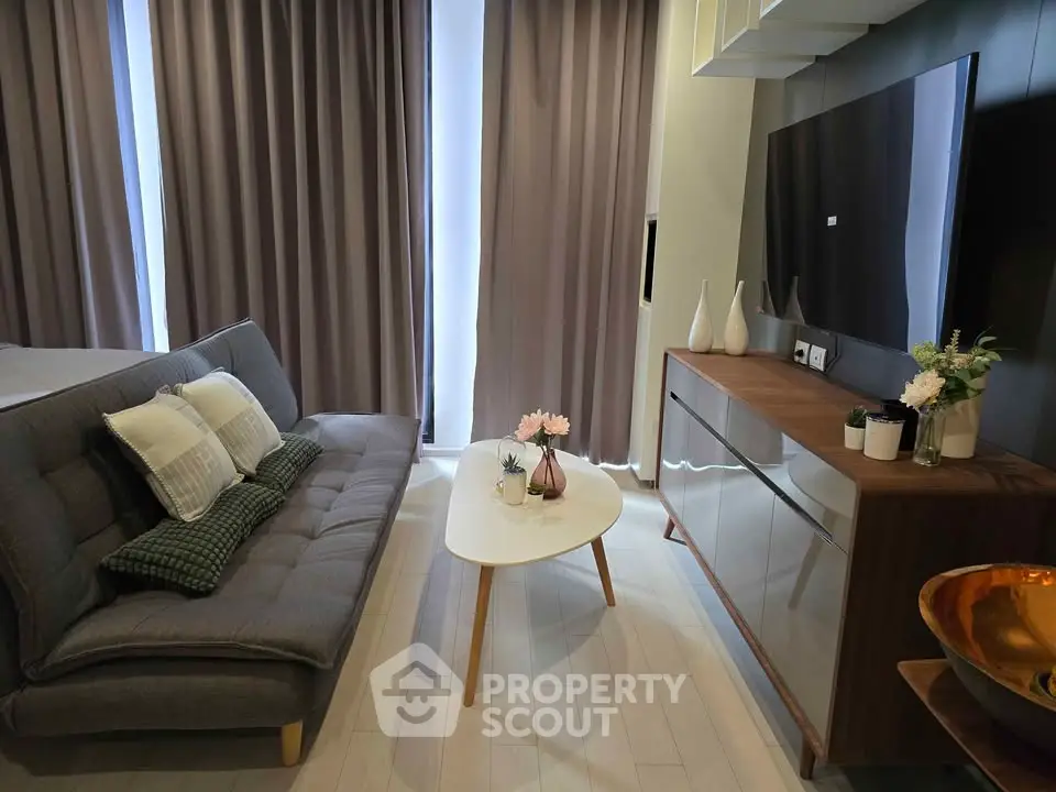 Modern living room with sleek furniture and stylish decor in a cozy apartment setting.