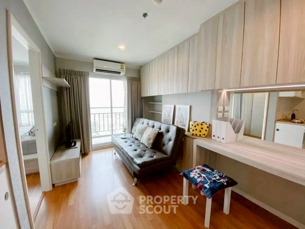 Modern living room with stylish decor and balcony view in a contemporary apartment.