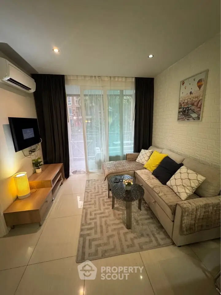 Cozy living room with modern decor, featuring a comfortable sofa, stylish coffee table, and wall-mounted TV.