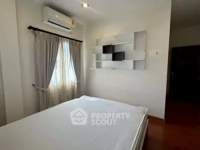 Cozy bedroom with modern shelving and natural light