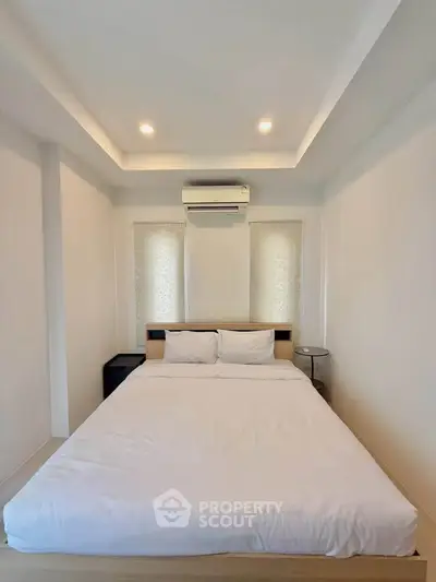 Modern minimalist bedroom with cozy bed and ambient lighting