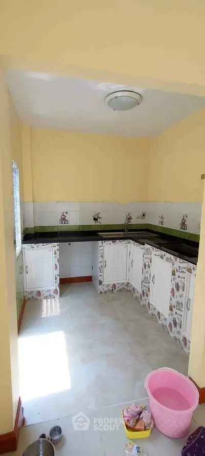 Charming kitchen with unique tile design and ample storage space