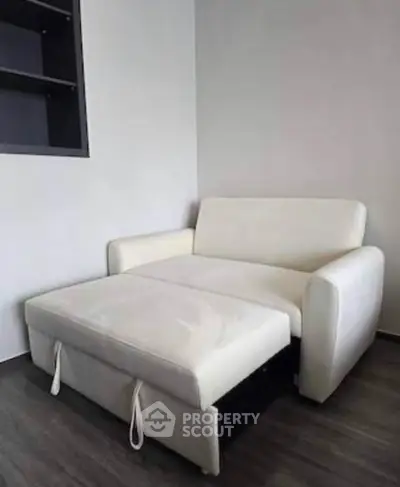 Modern white sofa bed in a minimalist living room with sleek flooring.