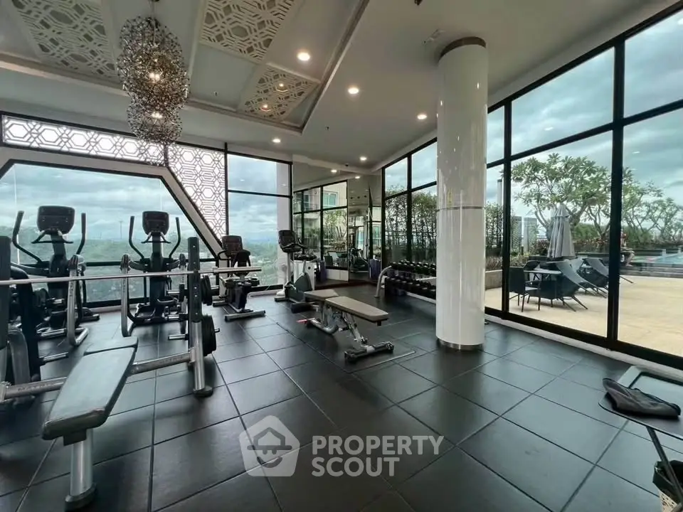 Luxurious gym with panoramic views and modern equipment in upscale residential building.