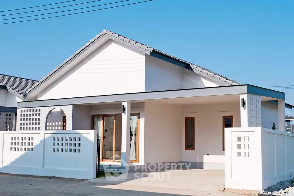Modern single-story house with minimalist design and spacious driveway.