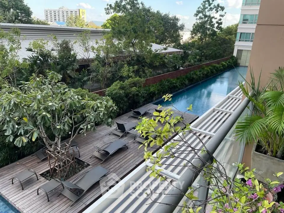 Luxurious apartment complex with serene poolside and lush greenery, perfect for relaxation and leisure.