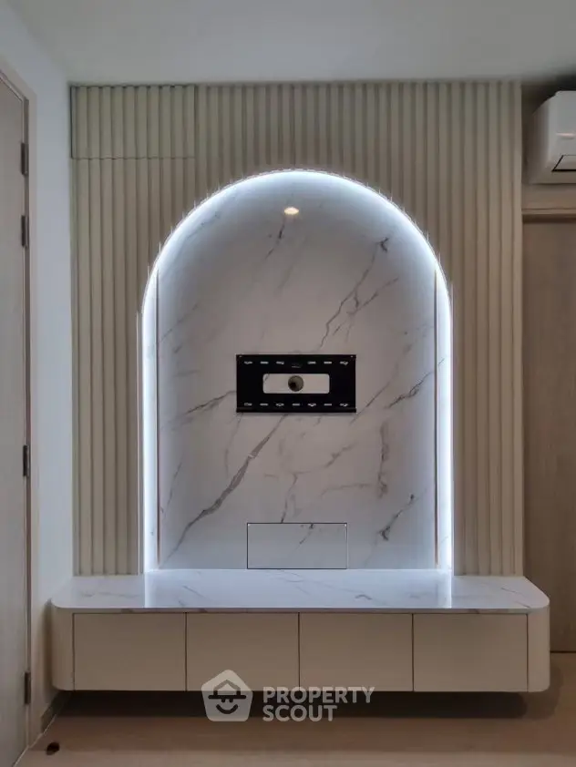 Modern living room with elegant marble TV wall and ambient lighting