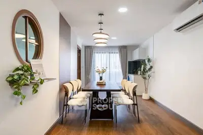 Modern dining room with elegant decor and natural light, featuring a stylish table and chairs, perfect for gatherings.