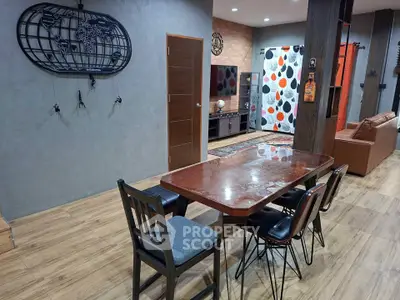 Stylish modern living room with dining area, featuring wooden flooring and contemporary decor.