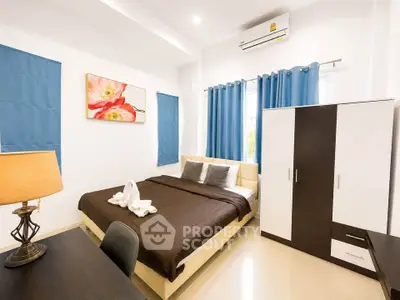Modern bedroom with stylish decor, featuring a comfortable bed, elegant wardrobe, and vibrant artwork.