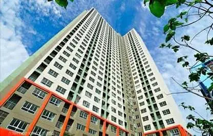 Stunning high-rise building with modern architecture against a vibrant blue sky.