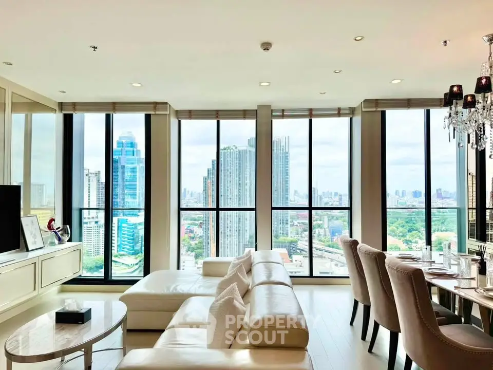 Luxurious living room with panoramic city views and elegant furnishings in a high-rise apartment.