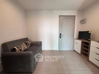 Modern living room with sleek gray sofa and minimalist decor