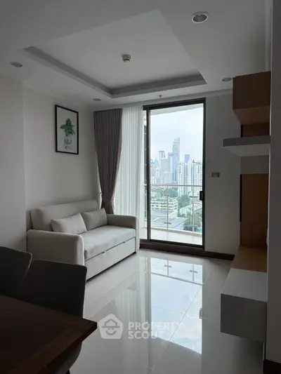 Modern living room with city view and sleek furnishings in high-rise apartment.
