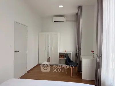 Modern bedroom with sleek furniture and air conditioning, perfect for comfort and style.