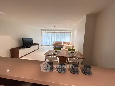Spacious living room with modern decor and natural light, perfect for relaxation and entertainment.