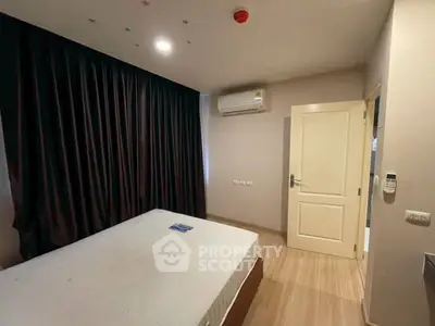Cozy bedroom with modern air conditioning and elegant dark curtains, perfect for restful nights.