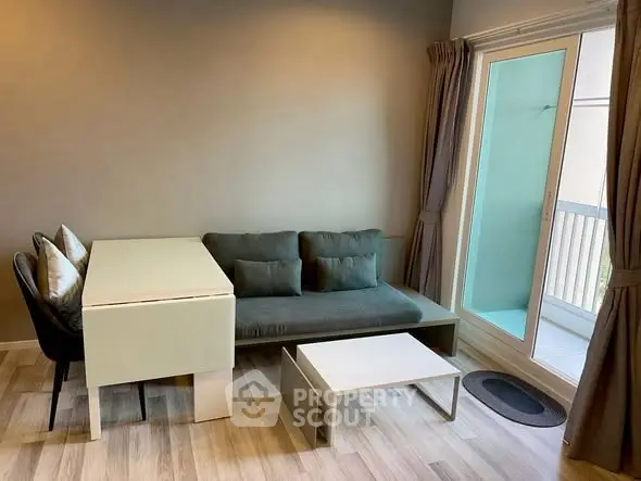 Modern living room with sleek furniture and balcony access