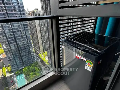 Modern balcony with washing machine and stunning city view in high-rise apartment.