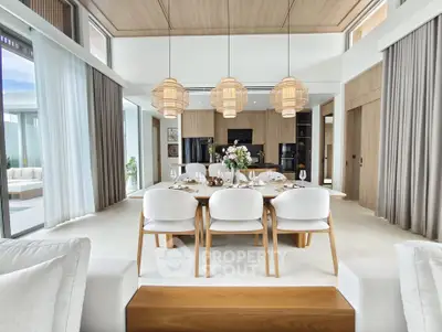 Luxurious open-plan dining and living area with elegant decor and natural light.