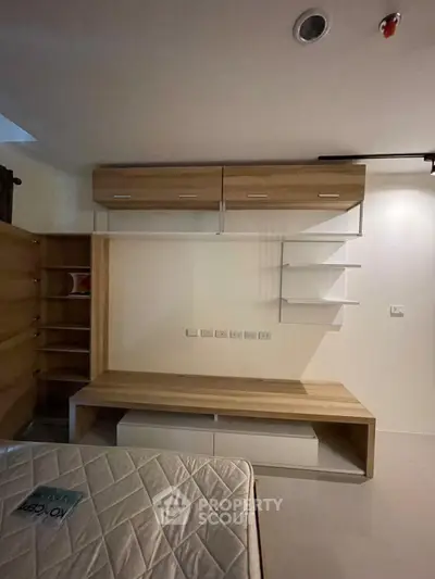 Modern bedroom with built-in wooden storage and cozy ambiance