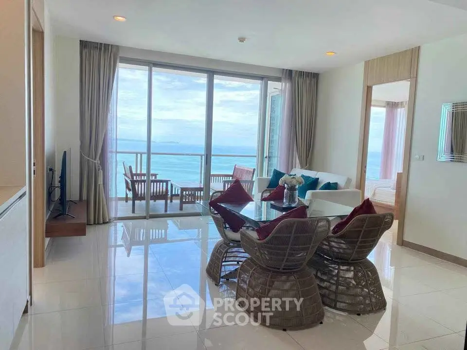 Stunning beachfront living room with panoramic ocean views and elegant decor.