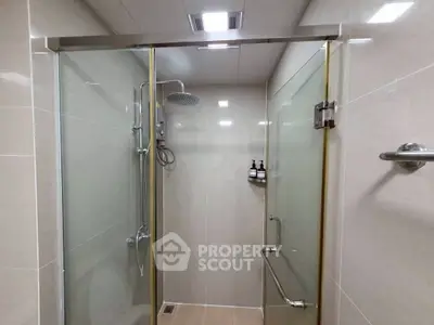 Modern bathroom with glass shower doors and sleek fixtures