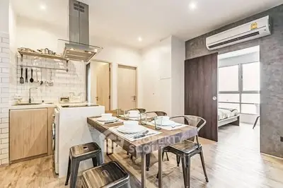 Modern open-layout kitchen and dining area with stylish decor and natural light