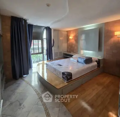 Luxurious bedroom with elevated platform bed and elegant design