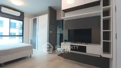 Modern bedroom with sleek built-in storage and large windows for natural light.