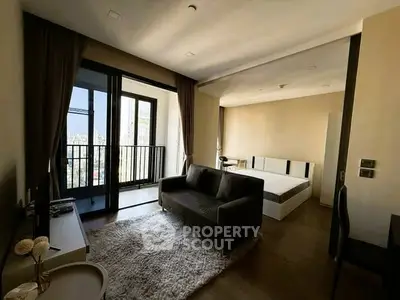 Modern studio apartment with balcony and city view, featuring cozy living area and stylish decor.