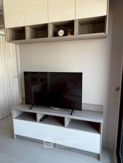 Modern living room with sleek TV stand and stylish shelving unit.