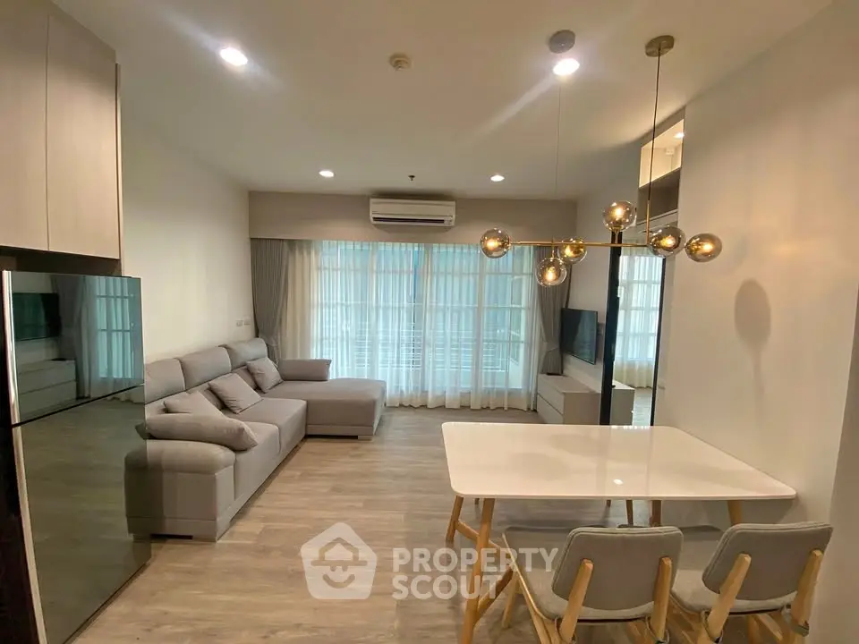 Modern living room with stylish furniture and elegant lighting in a cozy apartment.