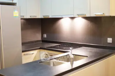 Modern kitchen with sleek countertops and built-in electric stove