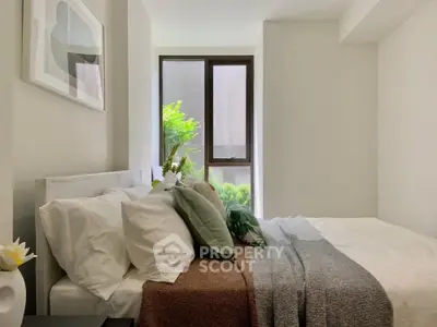 Cozy modern bedroom with large window and stylish decor
