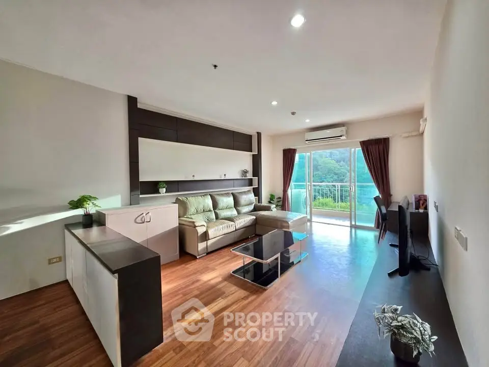 Spacious living room with modern decor and balcony view