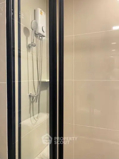 Modern bathroom with sleek shower enclosure and contemporary fixtures.