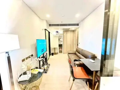 Modern living room with sleek furniture and TV, ideal for urban living.