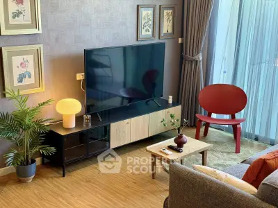 Stylish living room with modern decor and large TV, perfect for relaxation.