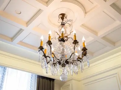 Elegant chandelier in a luxurious living room with coffered ceiling