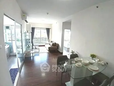Spacious living room with modern dining area and balcony view