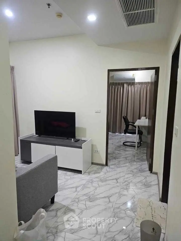 Modern living room with marble flooring and sleek furniture in a stylish apartment.