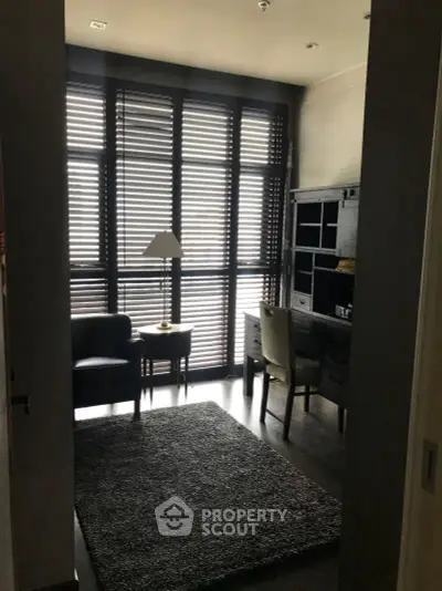 Cozy study room with modern furniture and large windows with blinds