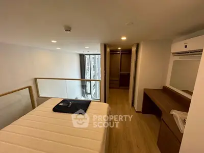 Modern bedroom with mezzanine view, featuring sleek design and ample natural light.