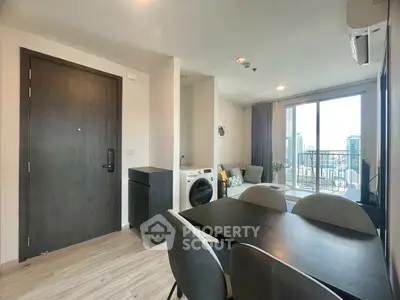 Modern apartment with open living area, dining space, and balcony view