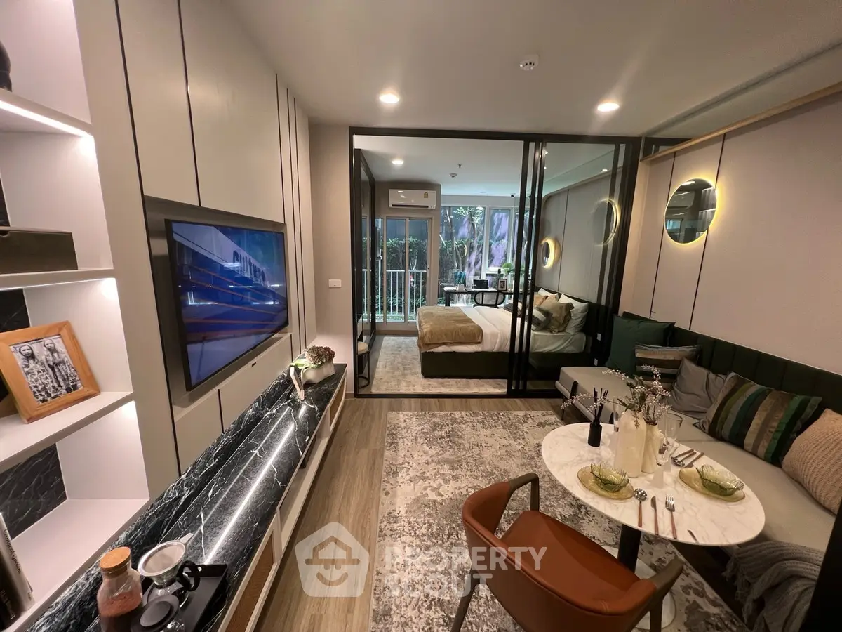 Modern studio apartment with stylish decor and open layout, featuring a cozy living area and bedroom.