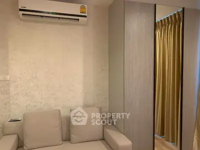 Cozy living room with modern air conditioning and stylish sofa, perfect for relaxation.