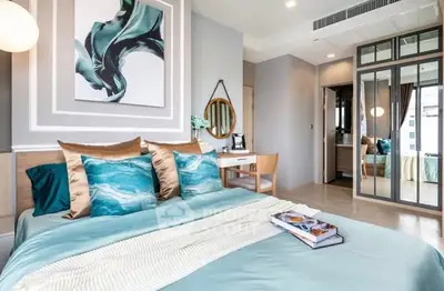 Luxurious bedroom with modern decor, stylish bedding, and elegant wall art in a contemporary apartment.