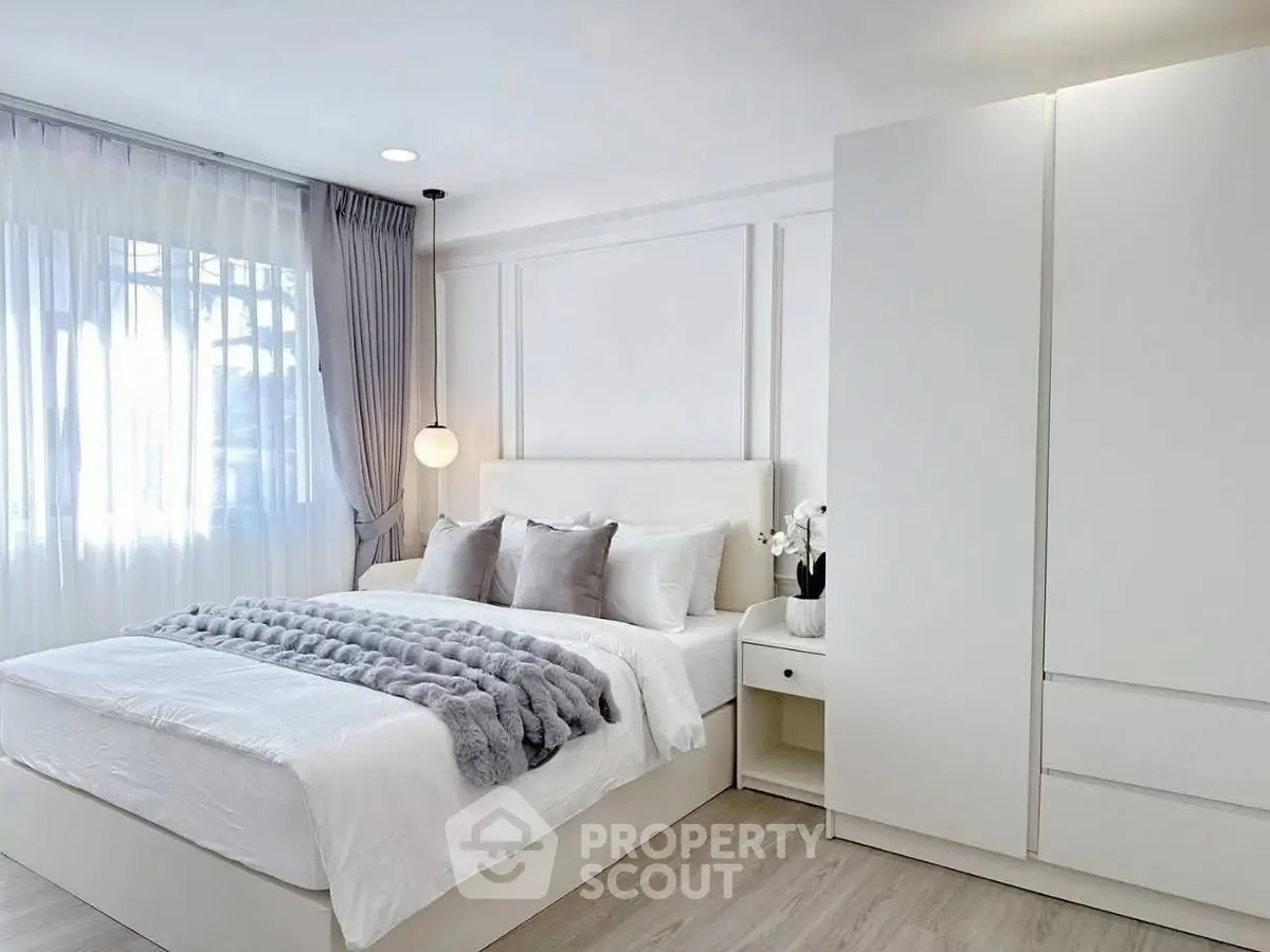 Elegant modern bedroom with natural light and stylish decor