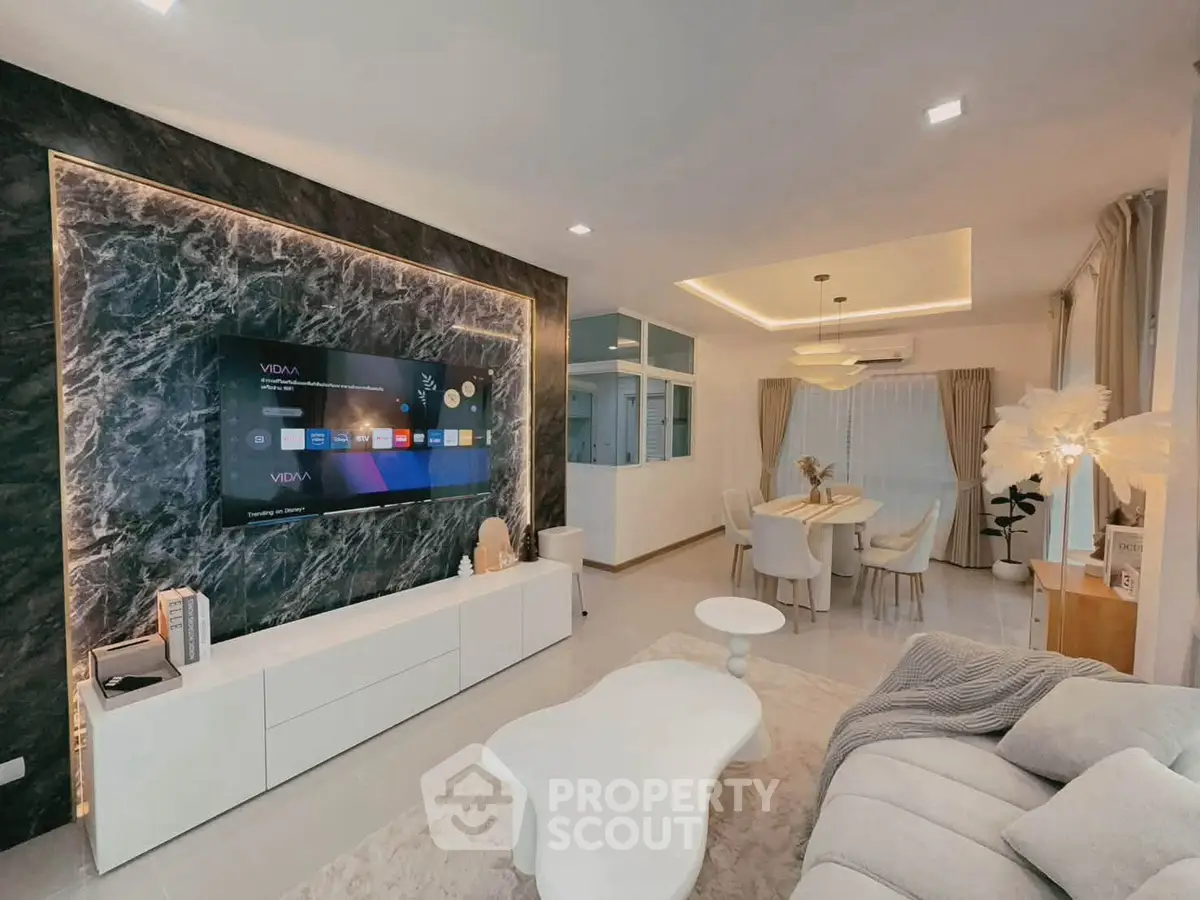 Luxurious modern living room with elegant dining area, featuring stylish decor and ambient lighting.